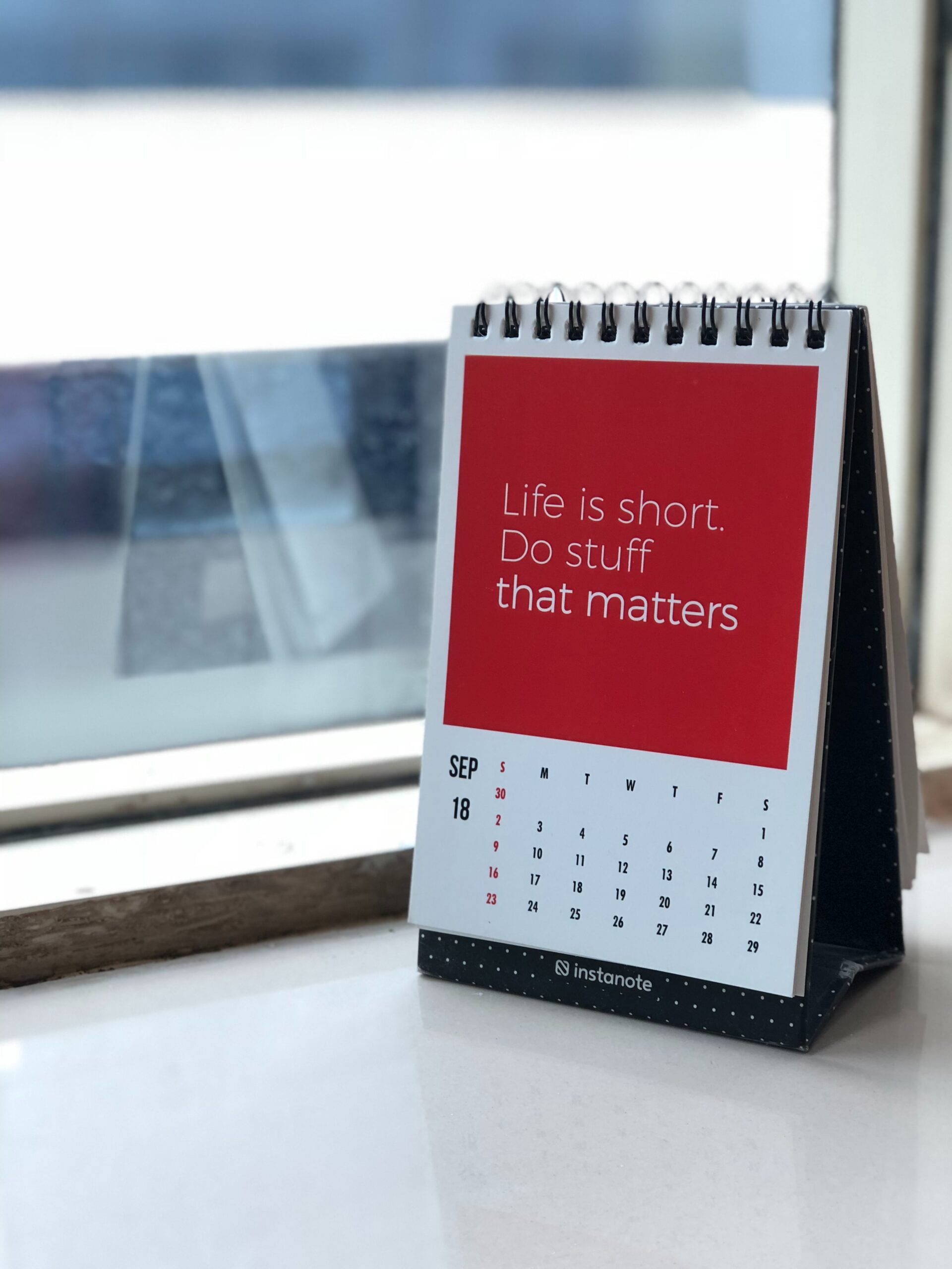 Planner sitting on a window sill with the slogan "Life is short. Do stuff that matters."