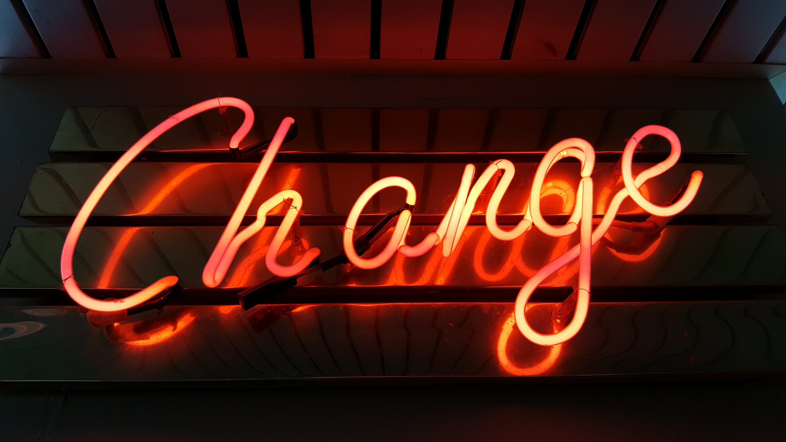 The word change lit up in orange against a black background