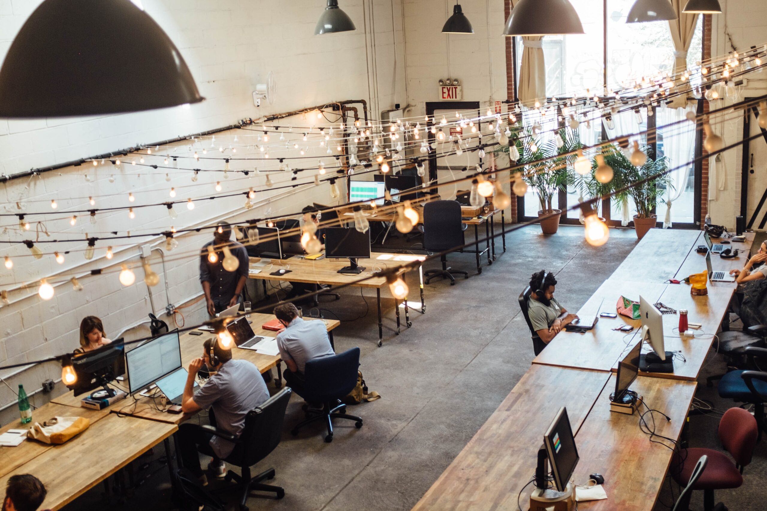 Photo of a large coworking space full of desks and people working