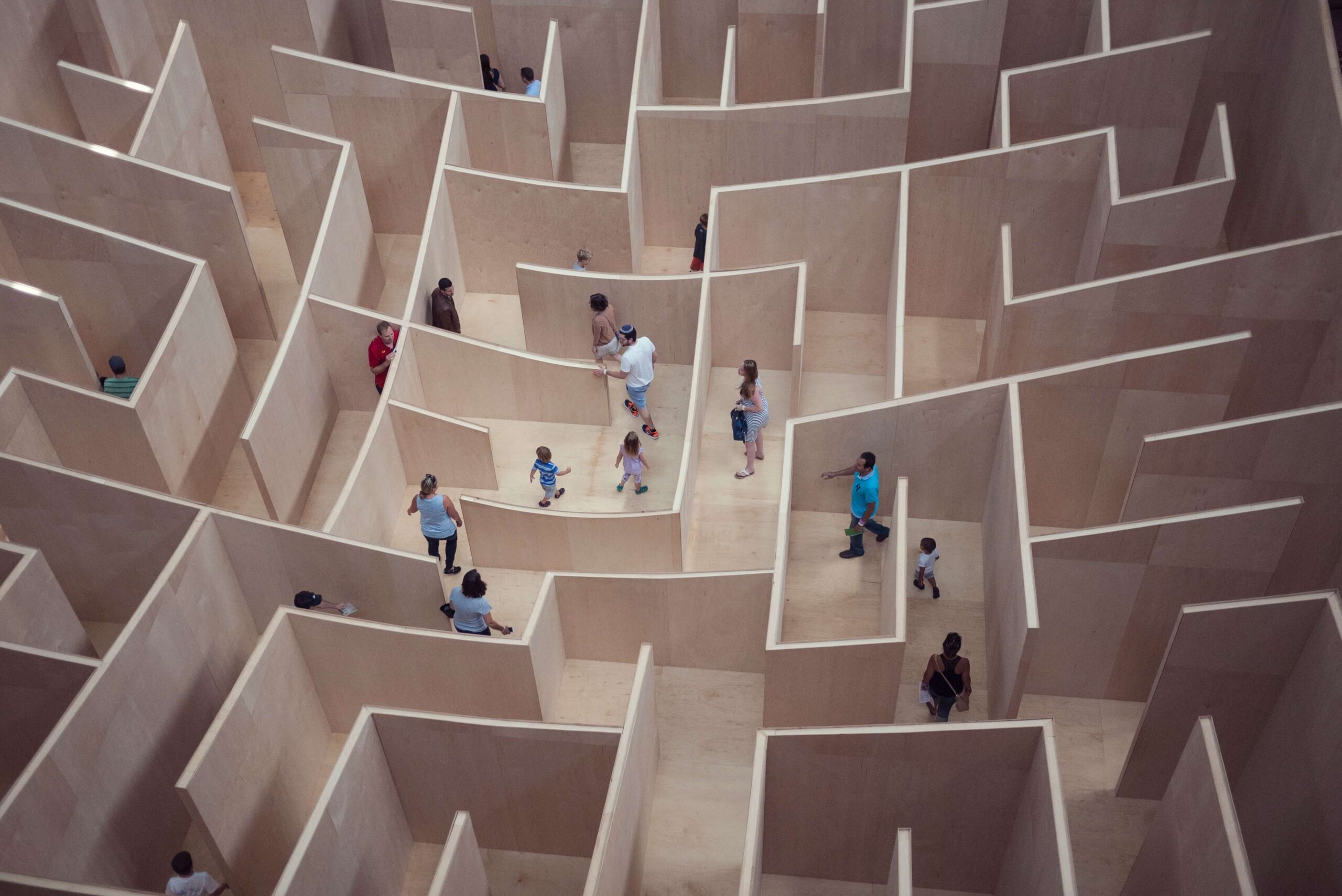 A range of people walking through a maze