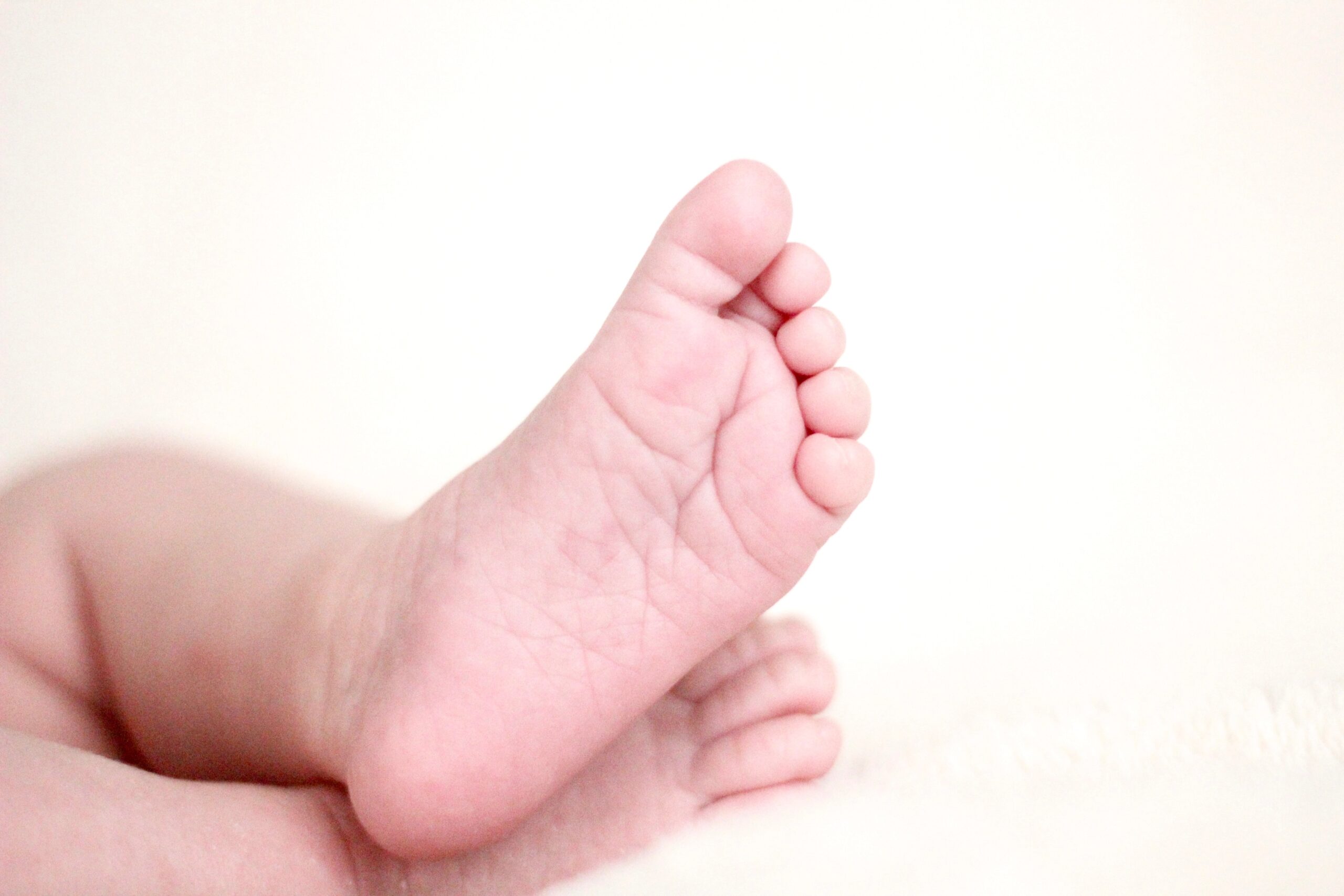 A pair of baby's feet on a white background