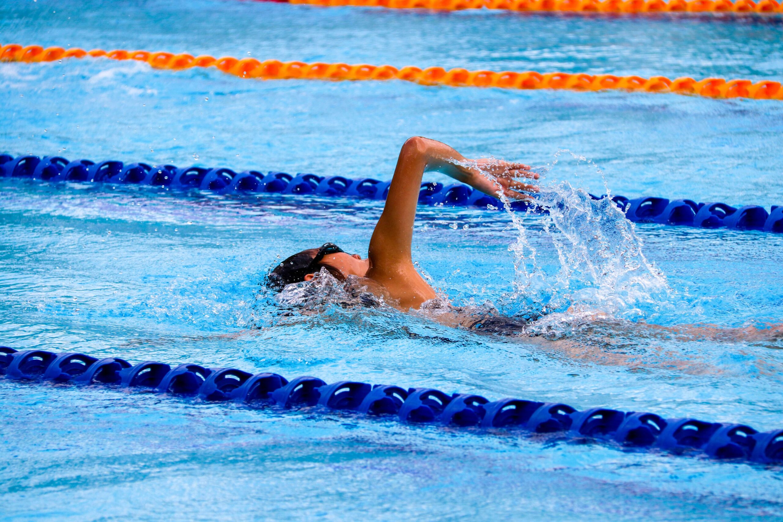 A woman doing front wall in the lanes of a swimming pool